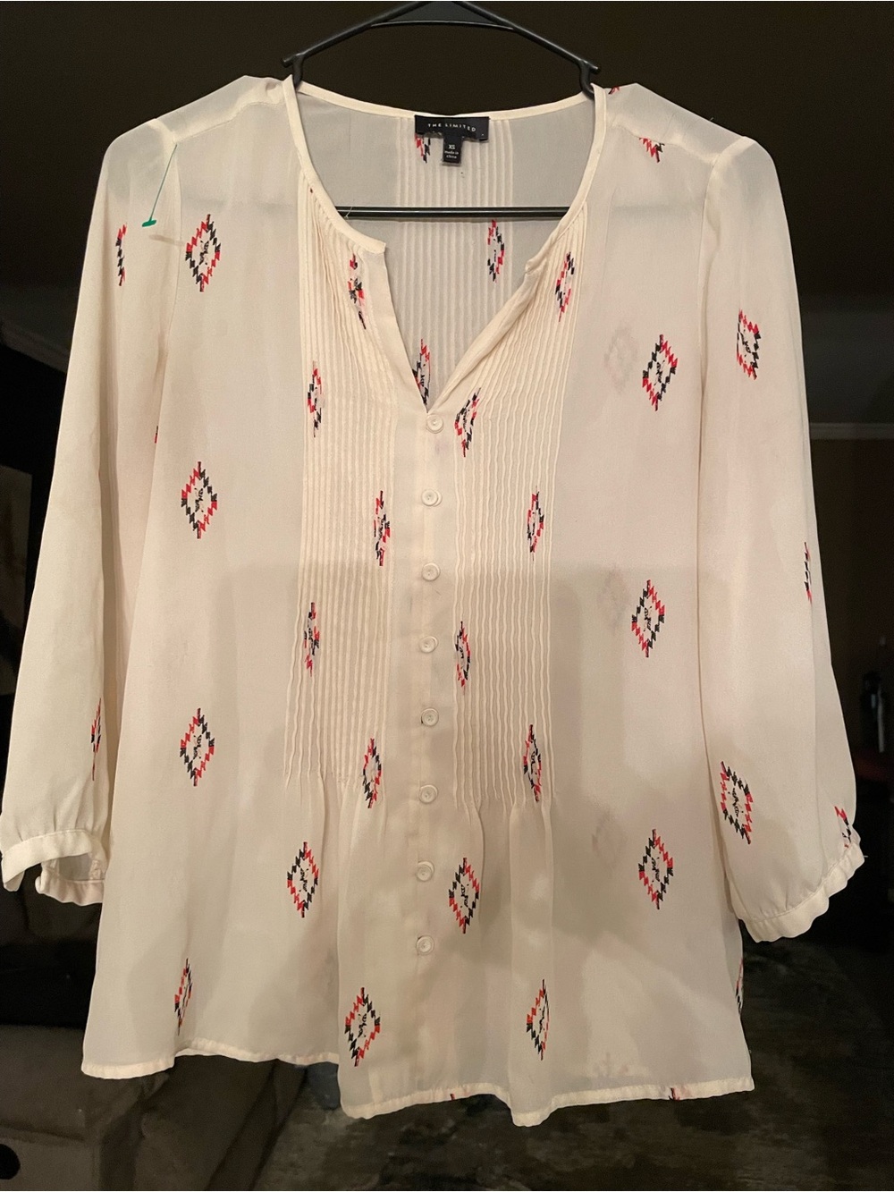 The limited Cream Button-Front Pintuck Blouse with Red & Black Diamond Print